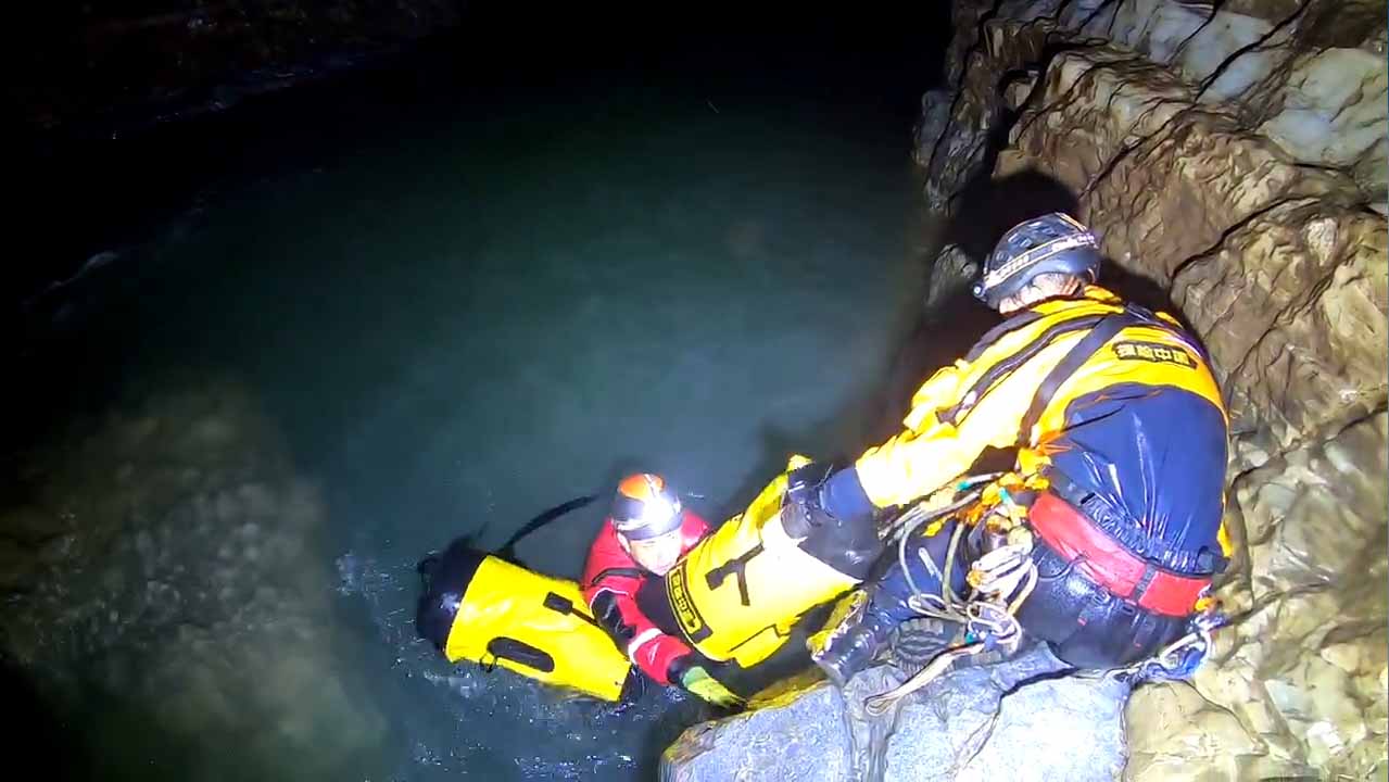 IPX8 waterproof caving backpack in a wet cave passage